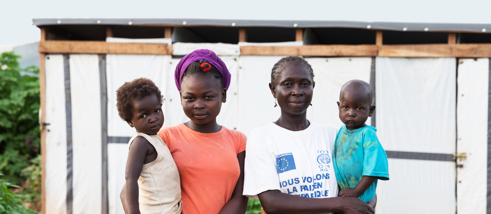 Family outside of a toilet block built by Toilet Twinning