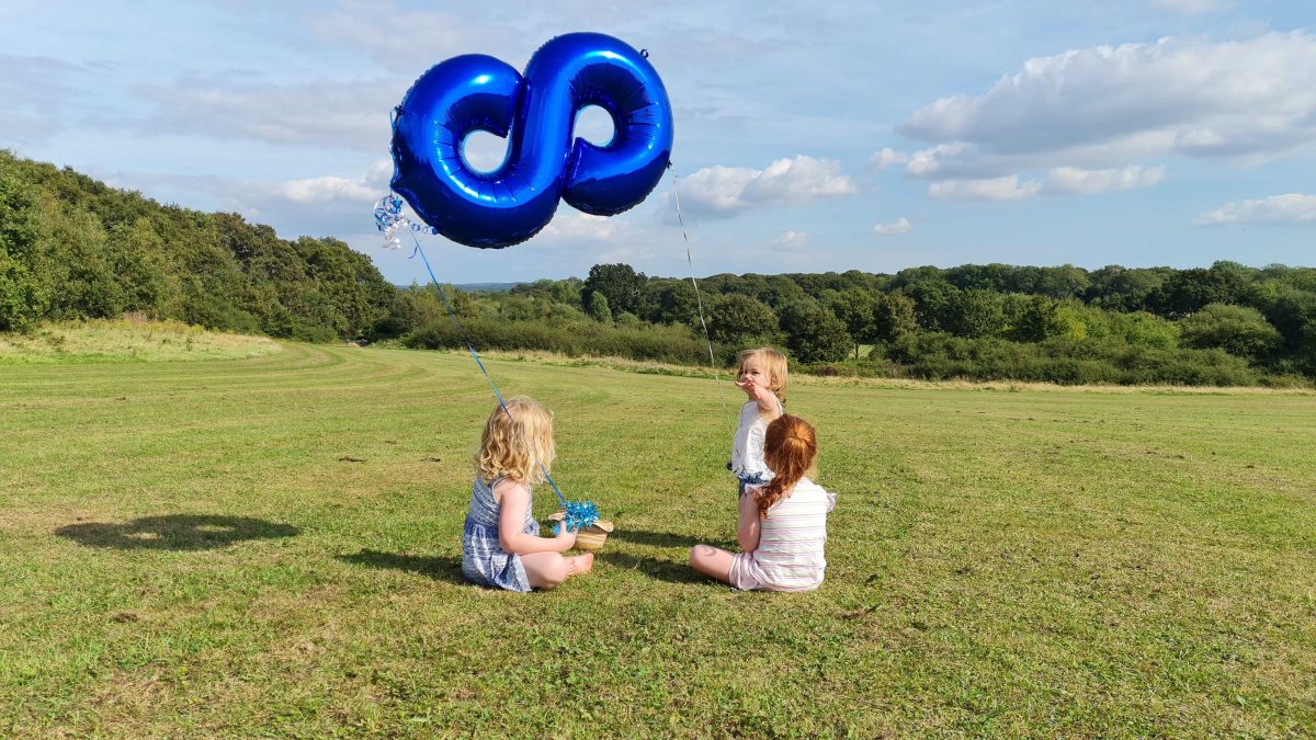 Girls in the field with the Rareloop balloon